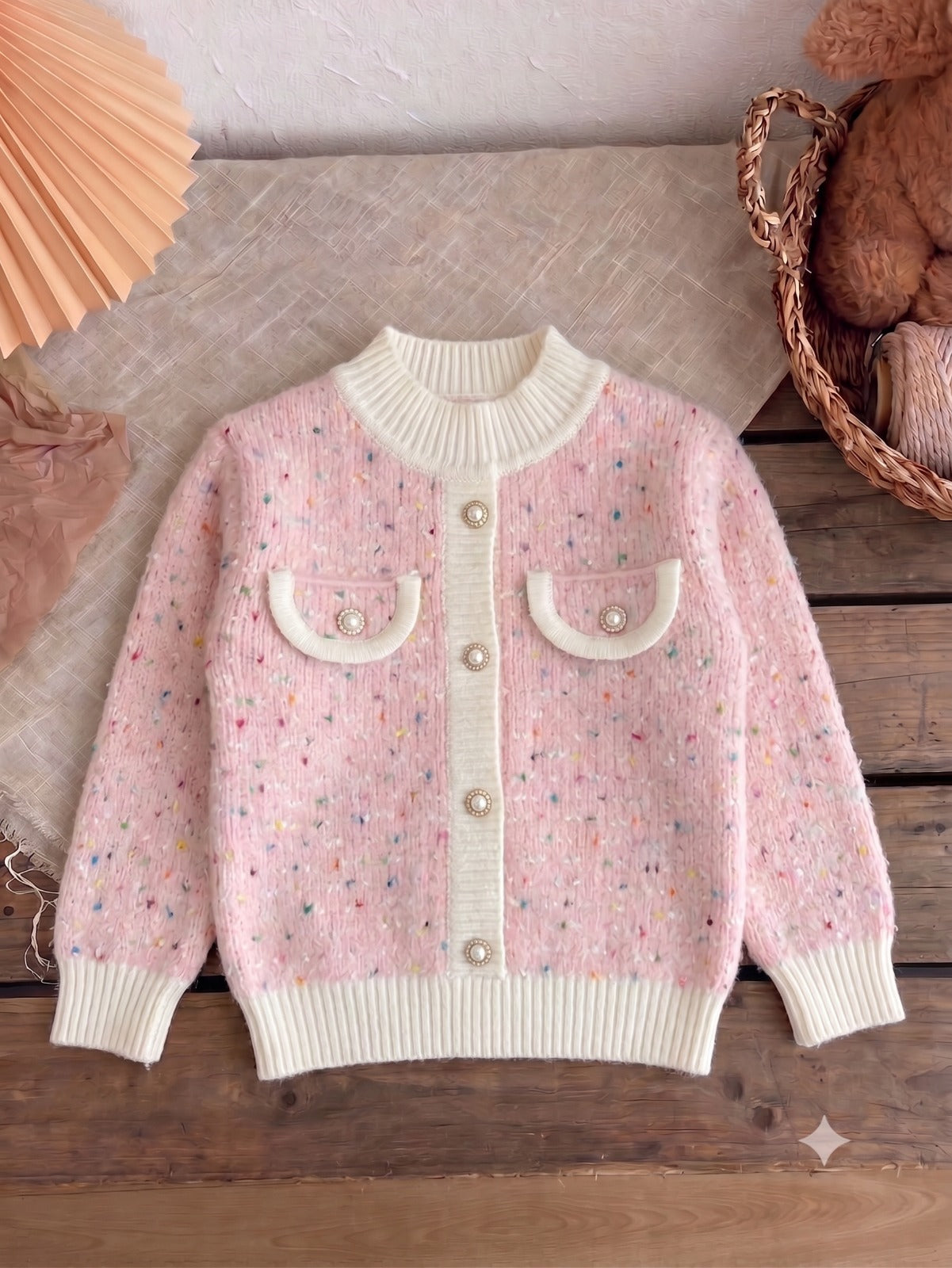 Blush sprinkle knit cardigan with cream ribbed trim and pearl buttons