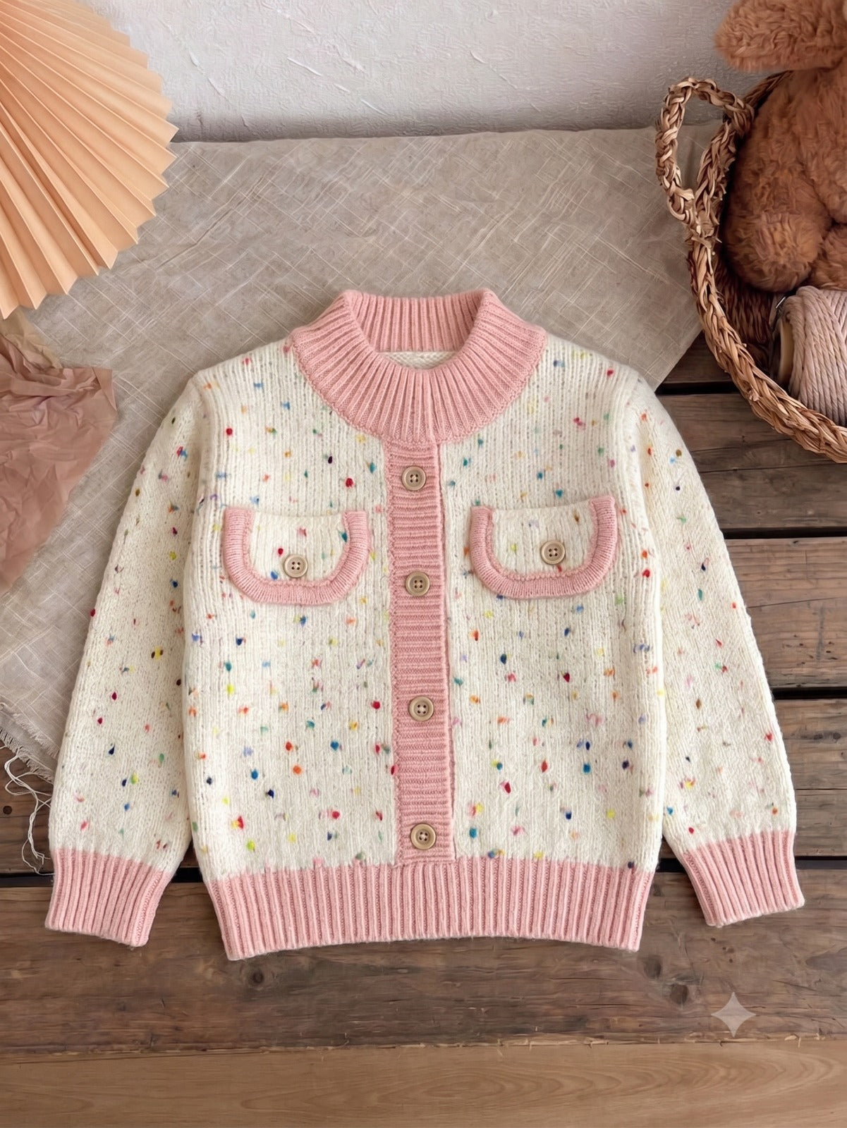 Cream sprinkle knit cardigan with blush ribbed trim and wooden buttons